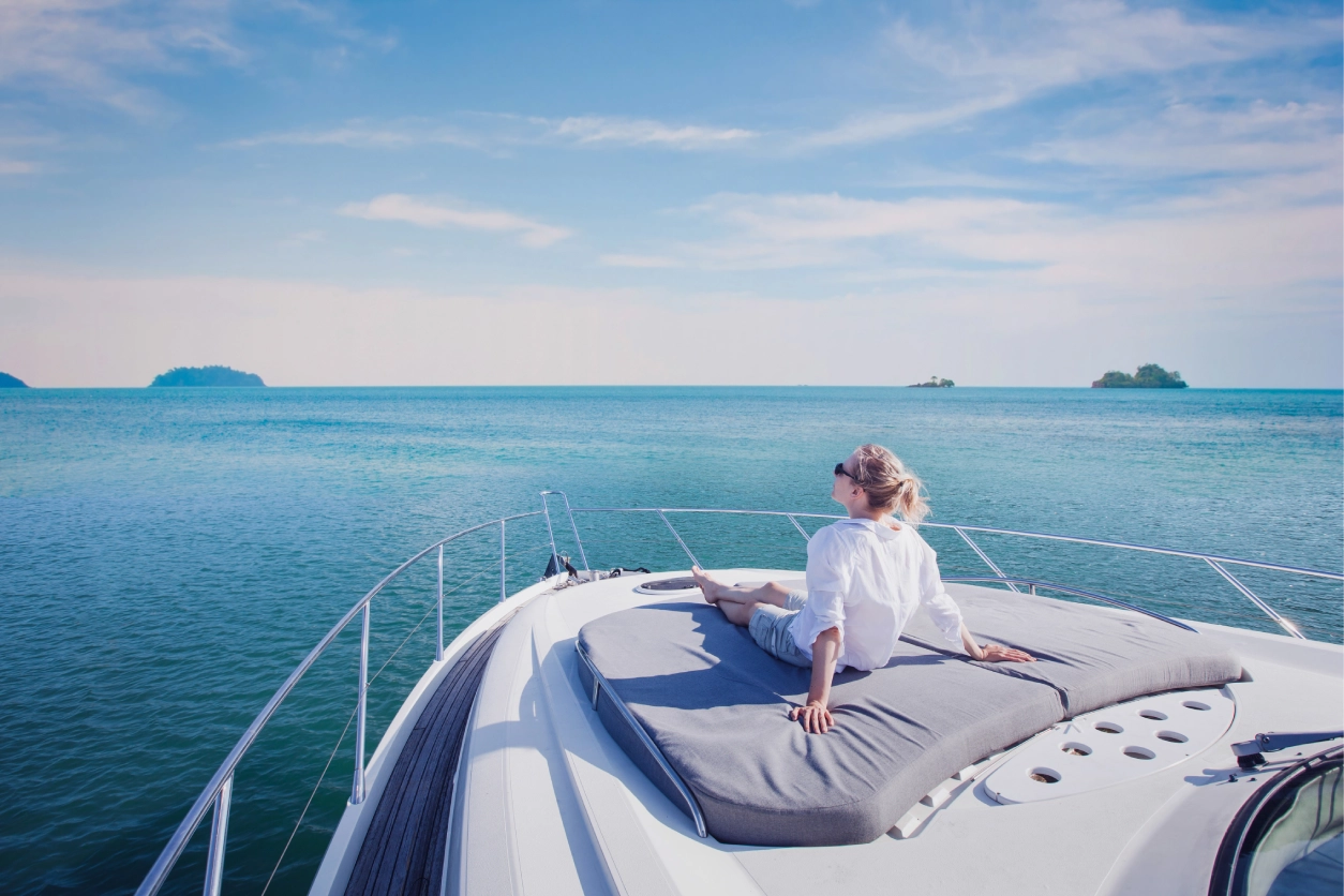 New Project (2) Woman relaxing on yacht in blue ocean.