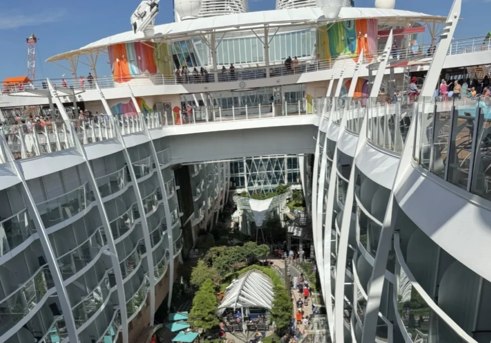 Cruise ship balcony view with green space.
