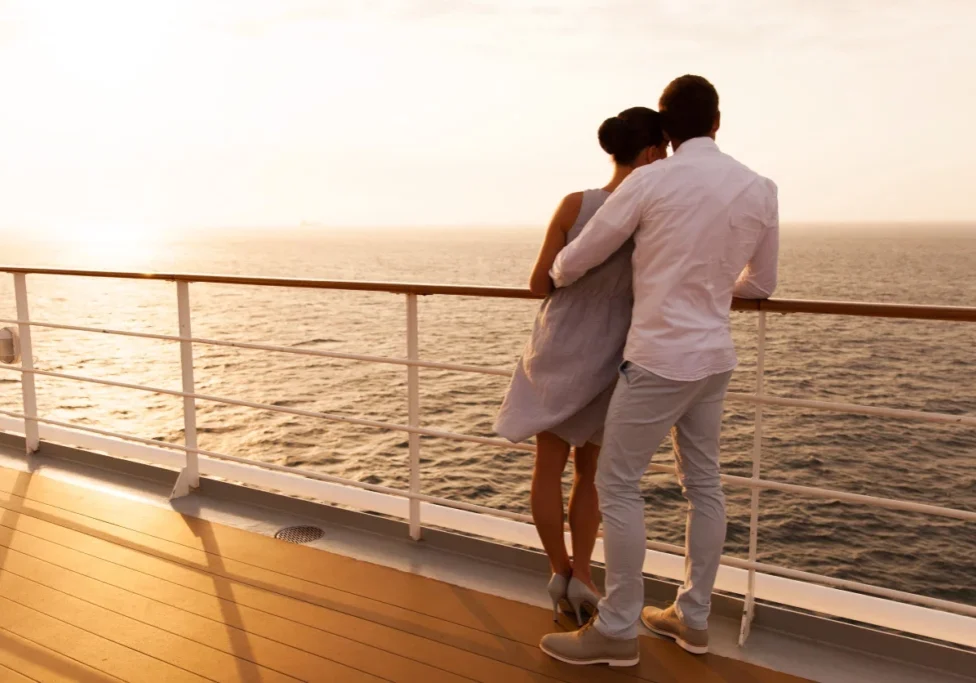 Couple on a cruise ship at sunset.